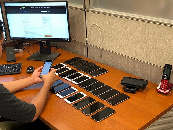 Picture of an employee testing mobile phones